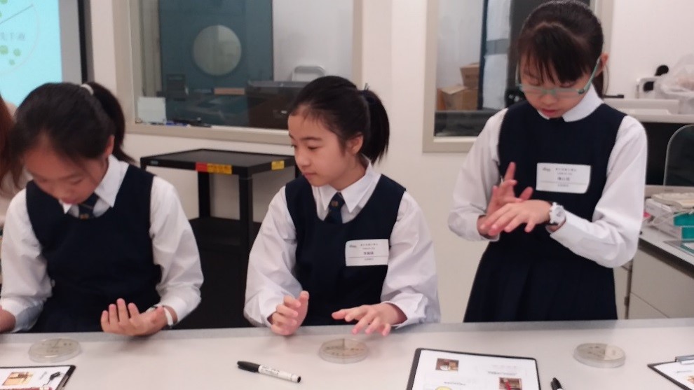 Students performing bacteria culturing experiment.